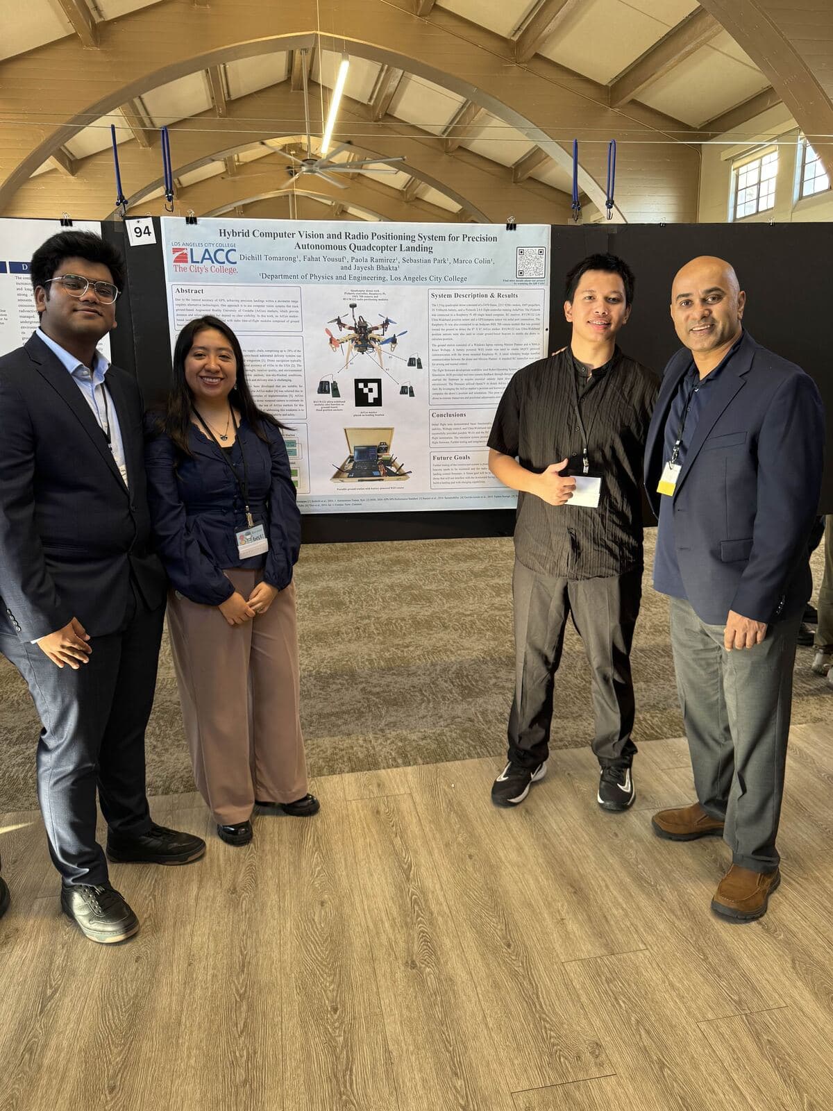 Members presenting a research poster on autonomous quadcopter landing