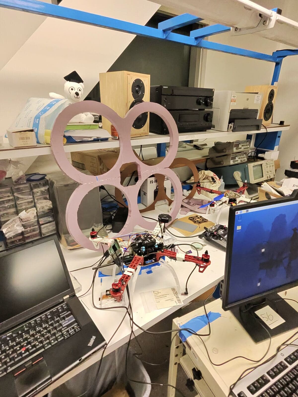 Quadcopter drone prototype on a busy engineering workbench